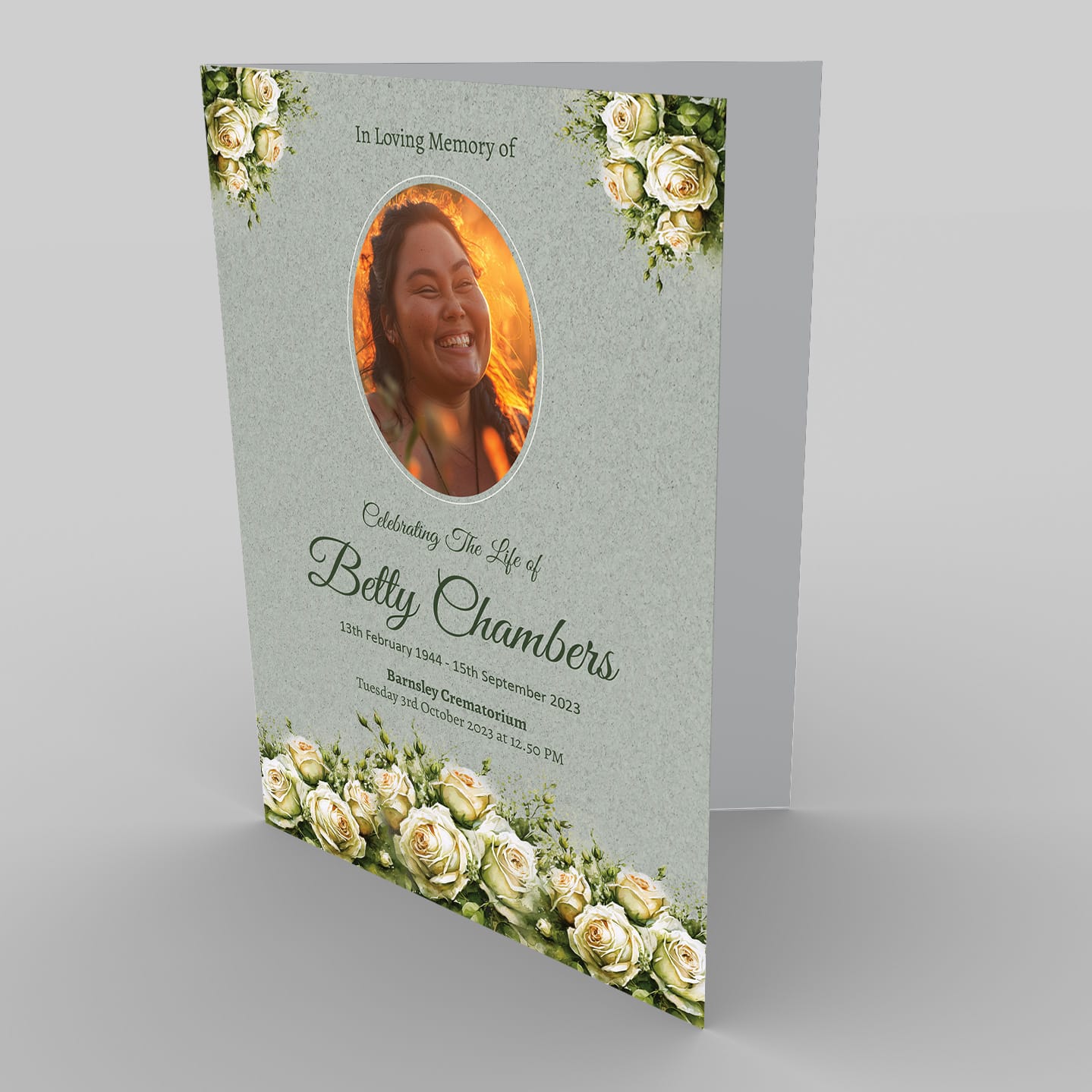 A memorial card featuring a tribute to Betty Chambers, with her photo surrounded by 2.7.2 White Rose and Green flowers, commemorating her life from 1944-2023.